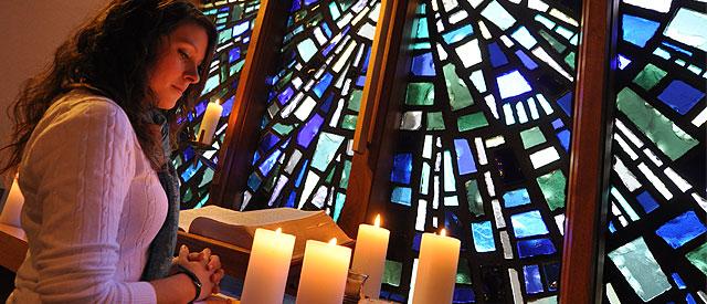 a Carroll University student standing in the chapel.